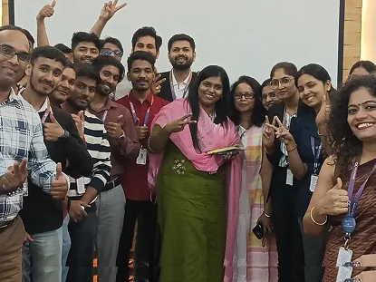 QKTech colleagues cheering with thumbs up after a Speakers Club session